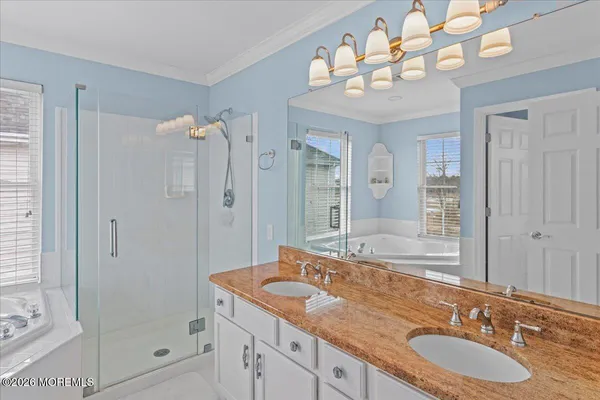 a bathroom with a granite countertop sink a mirror and a shower