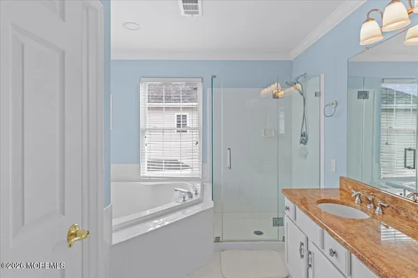 a bathroom with a granite countertop sink a toilet and shower