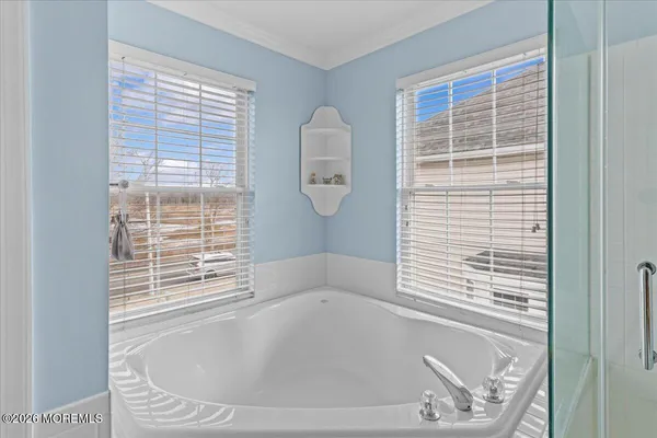 a bath tub sitting in a bathroom next to a window
