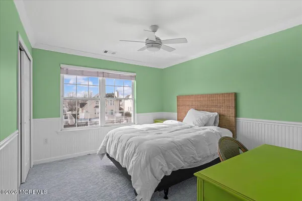 a bedroom with a bed and a large window