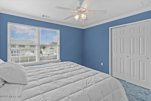 a bedroom with a large bed and a large window