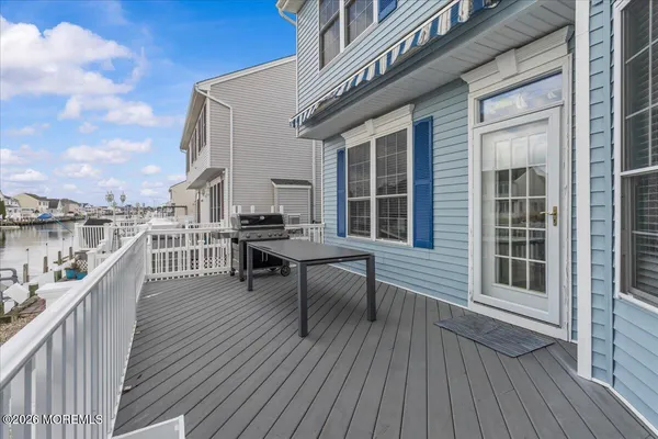 a balcony with wooden floor and furniture