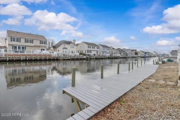 a view of a lake with a houses in the background