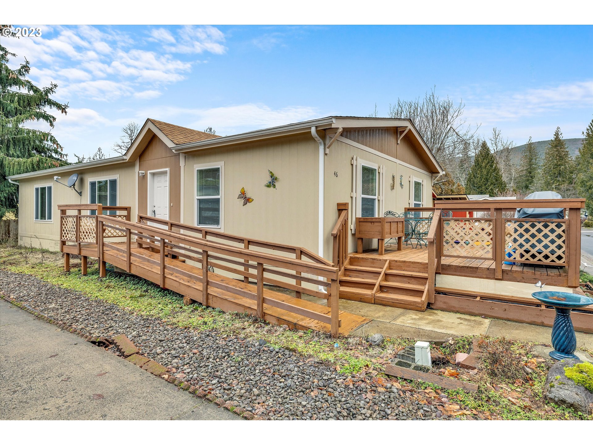 25222 East Welches Road, Unit 46 Welches, OR 97067 - Photo 27 of 30 a view of a house with a yard and wooden fence