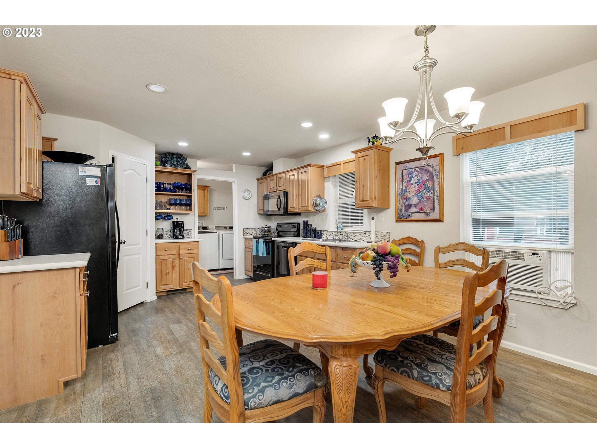 25222 East Welches Road, Unit 46 Welches, OR 97067 - Photo 8 of 30 a kitchen with stainless steel appliances kitchen island granite countertop a table chairs and a refrigerator