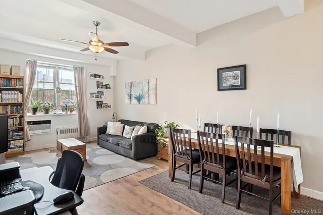 a living room with furniture a chandelier and a dining table