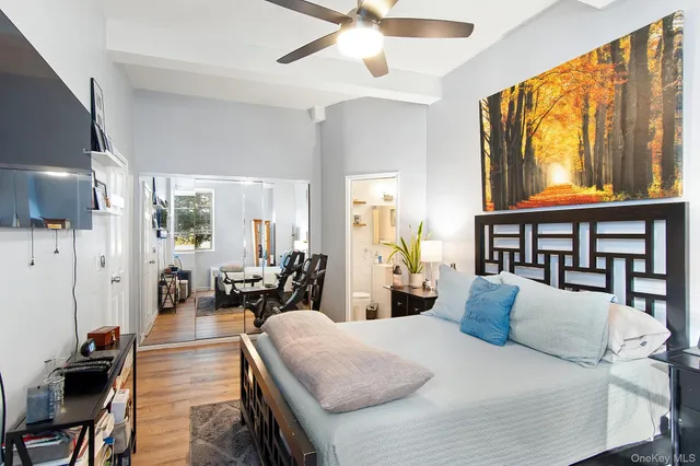 a large bedroom with a large bed and a large window