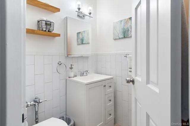 a bathroom with a sink mirror toilet and vanity