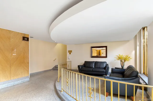 a front view of a house with a yard and potted plants