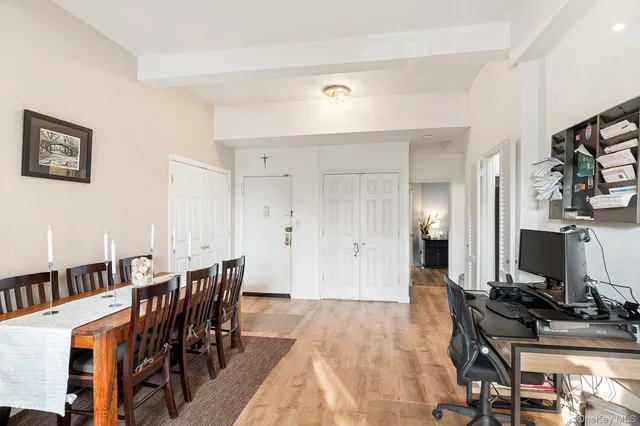 a view of a dining room with furniture and a flat screen tv