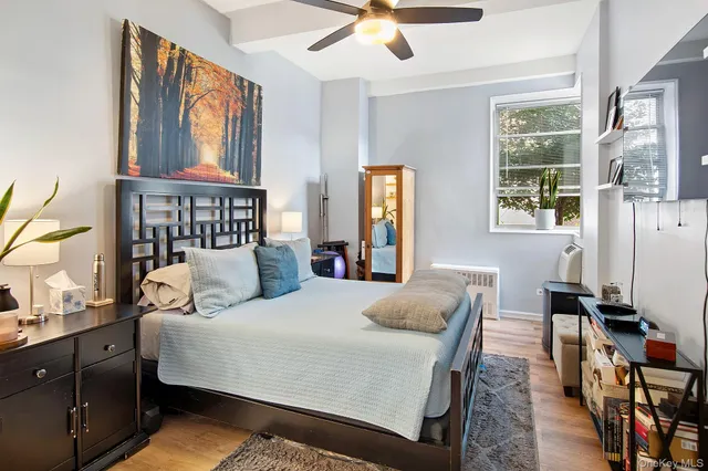 a bedroom with a bed window and a table