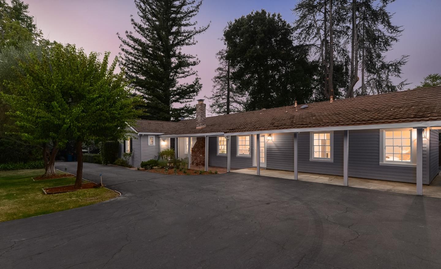 148 Bardet Road Woodside, CA 94062 - Photo 2 of 39 a front view of a house with a yard and garage