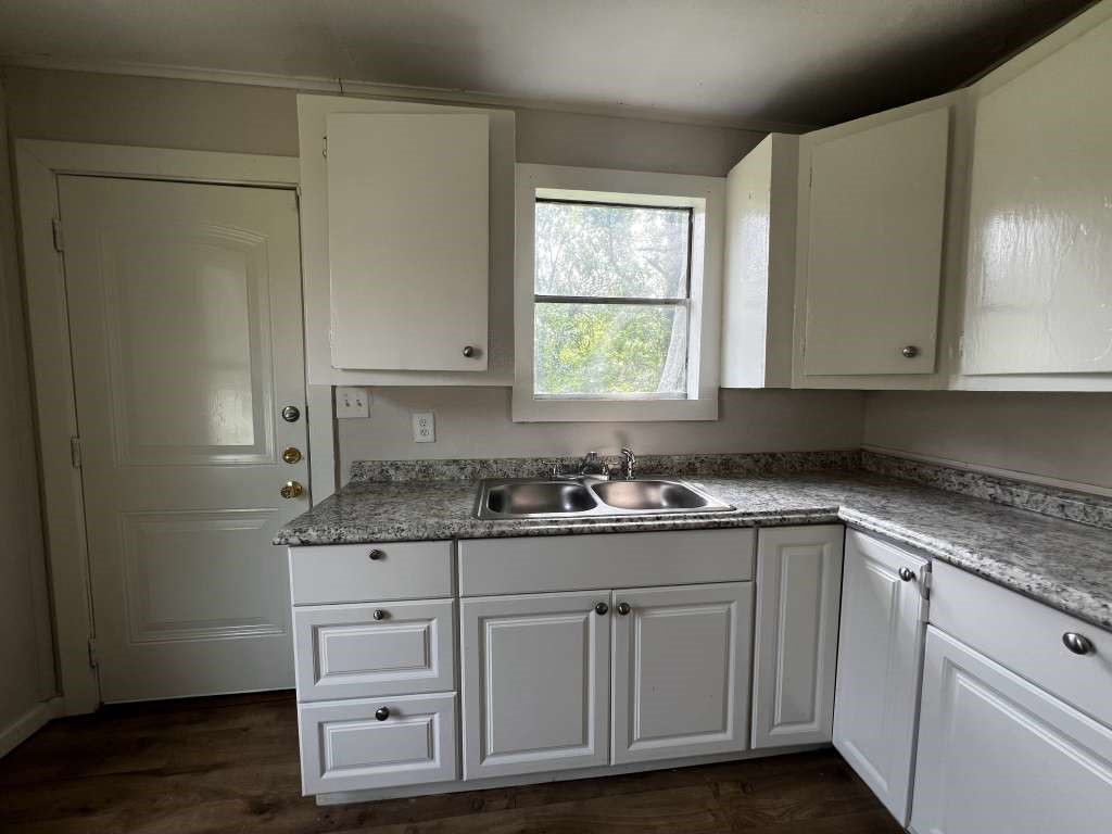8606 Prairie View Drive Houston, TX 77088 - Photo 7 of 15 a kitchen with white cabinets and sink