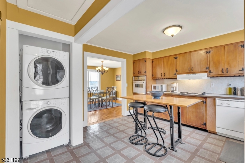 1595 Highway 206 Bedminster, NJ 07921 - Photo 18 of 24 a kitchen with stainless steel appliances granite countertop a table chairs sink and cabinets