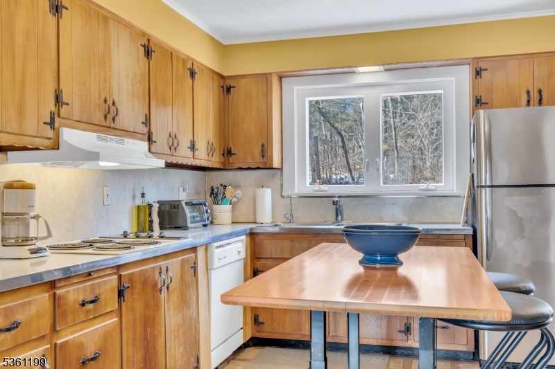 1595 Highway 206 Bedminster, NJ 07921 - Photo 19 of 24 a kitchen with stainless steel appliances granite countertop a table chairs sink and cabinets