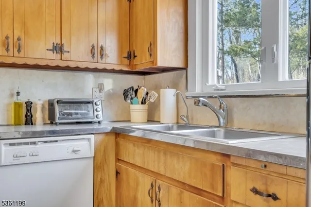 a kitchen with a window and cabinets