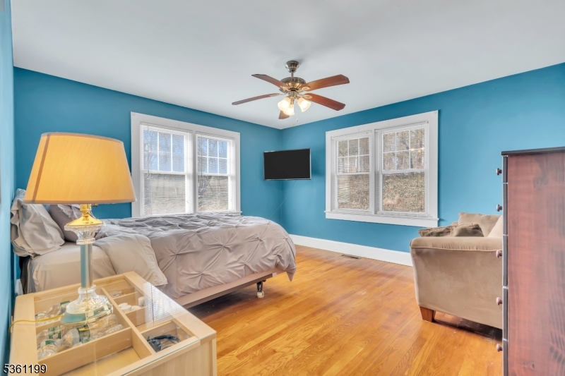 1595 Highway 206 Bedminster, NJ 07921 - Photo 21 of 24 a bedroom with a bed and wooden floor
