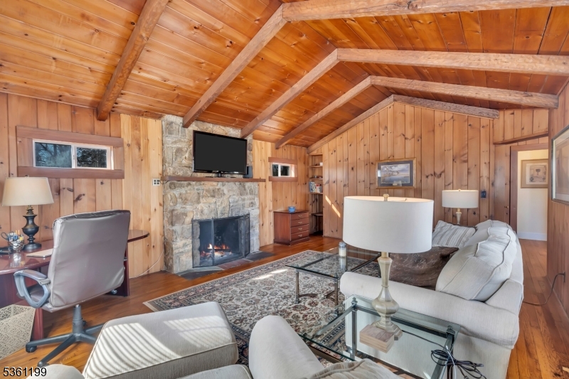 1595 Highway 206 Bedminster, NJ 07921 - Photo 10 of 24 a living room with furniture a fireplace and a flat screen tv
