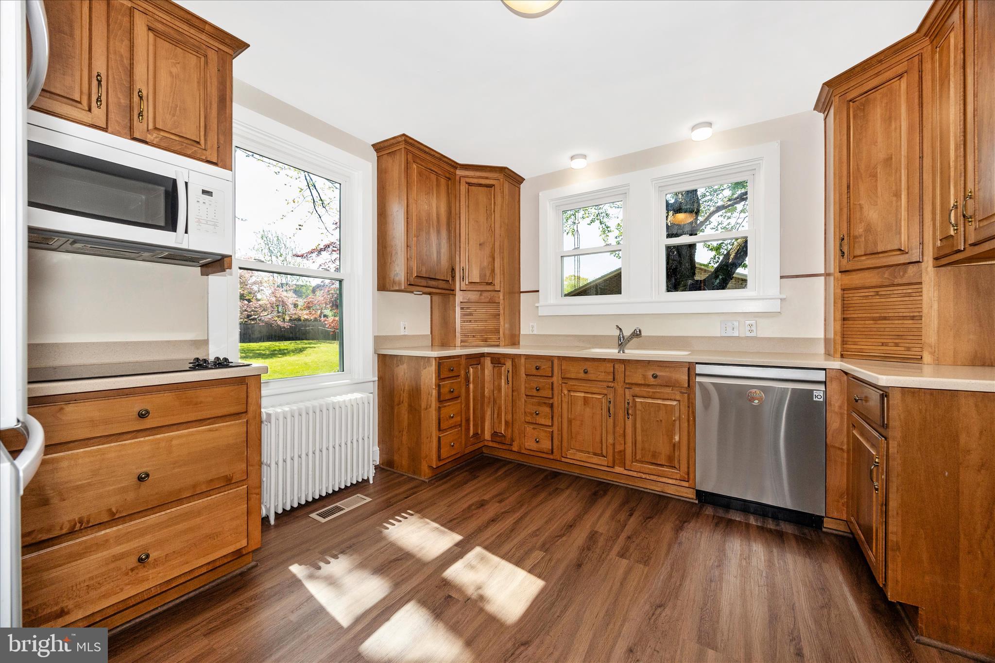 2 Catoctin Avenue Frederick, MD 21701 - Photo 12 of 63 a kitchen with stainless steel appliances kitchen island granite countertop a refrigerator a stove and a wooden floors