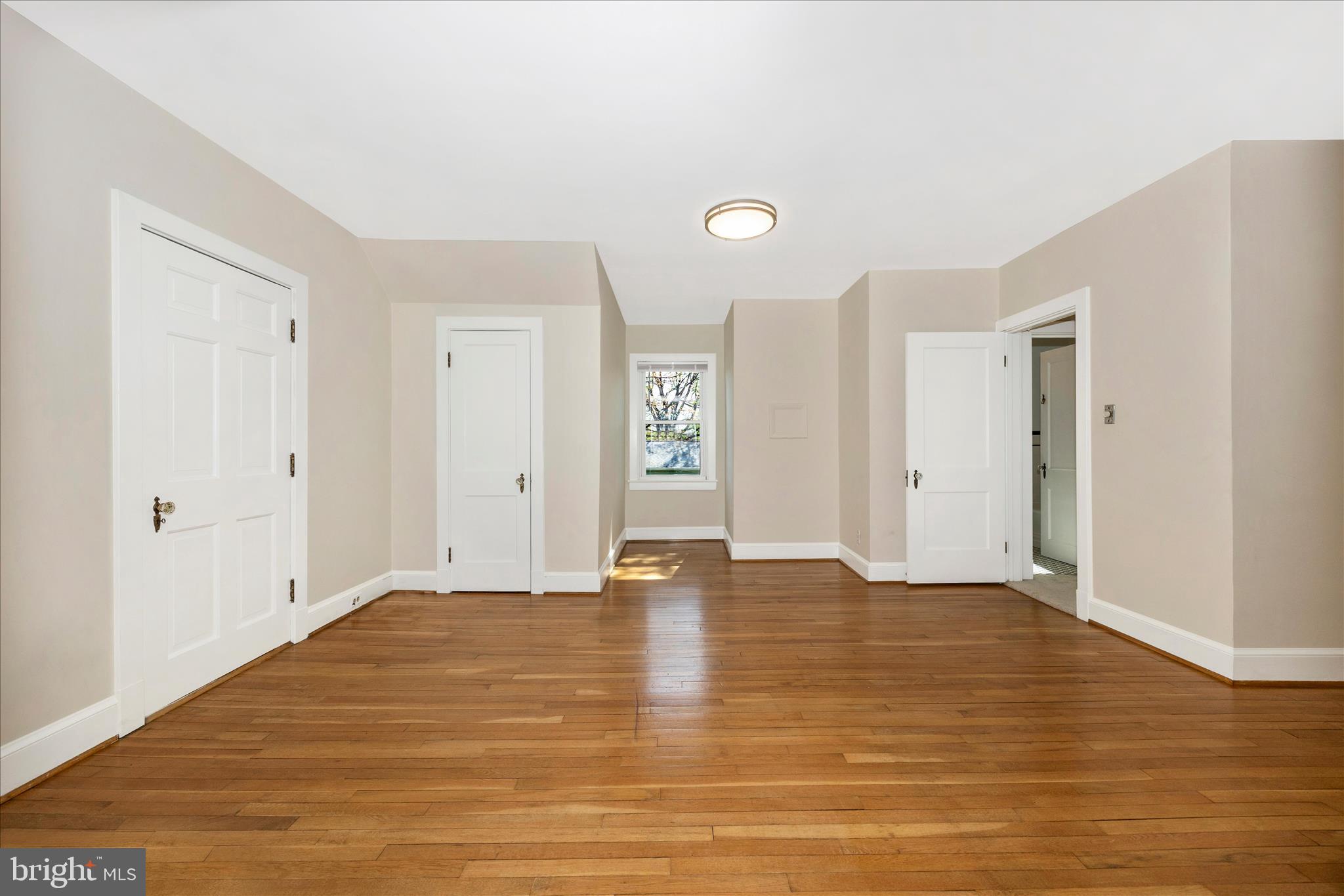 2 Catoctin Avenue Frederick, MD 21701 - Photo 22 of 63 a view of an empty room with window and wooden floor