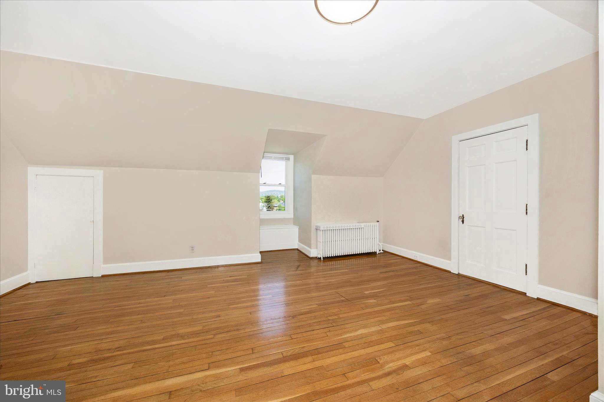 2 Catoctin Avenue Frederick, MD 21701 - Photo 23 of 63 a view of an empty room with wooden floor and window