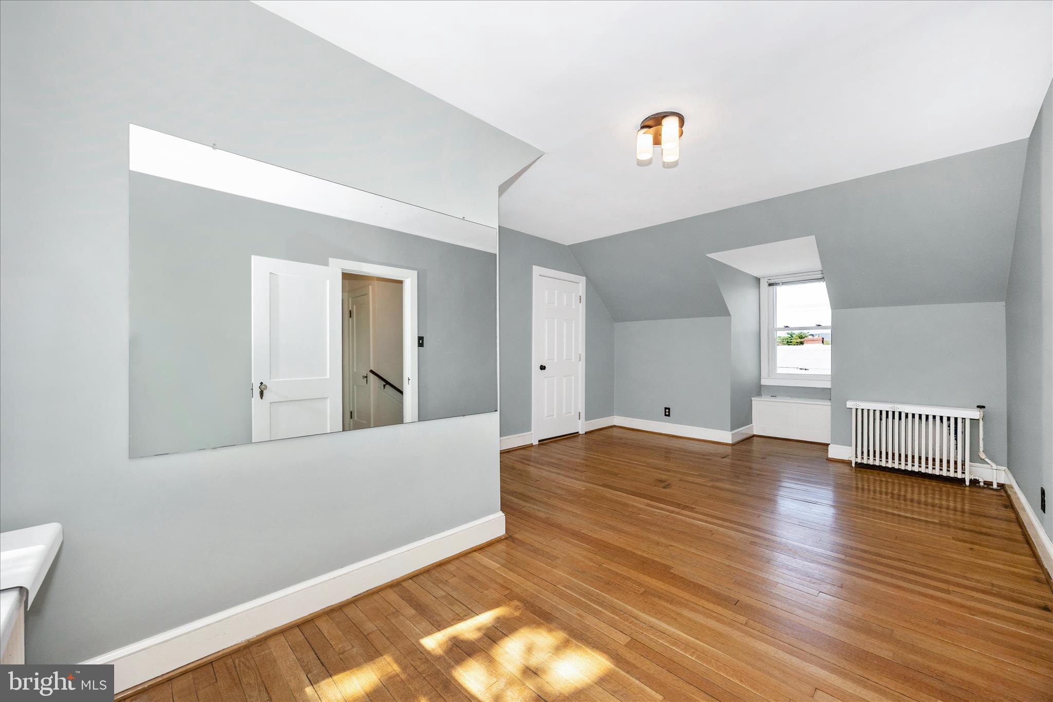 2 Catoctin Avenue Frederick, MD 21701 - Photo 27 of 63 a view of an empty room with wooden floor and a window
