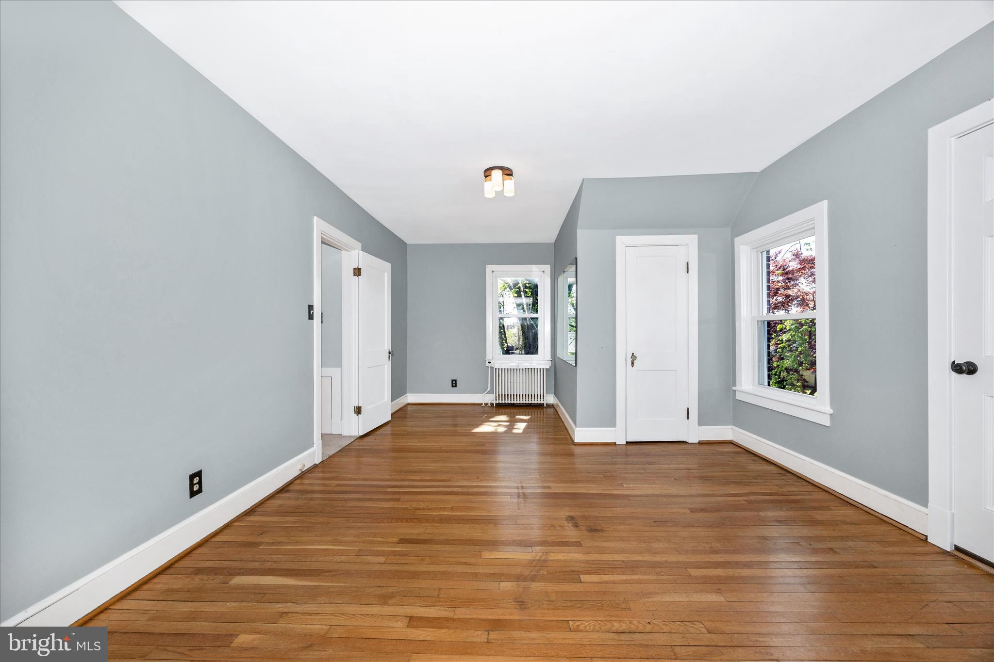 2 Catoctin Avenue Frederick, MD 21701 - Photo 28 of 63 a view of an empty room with window and wooden floor