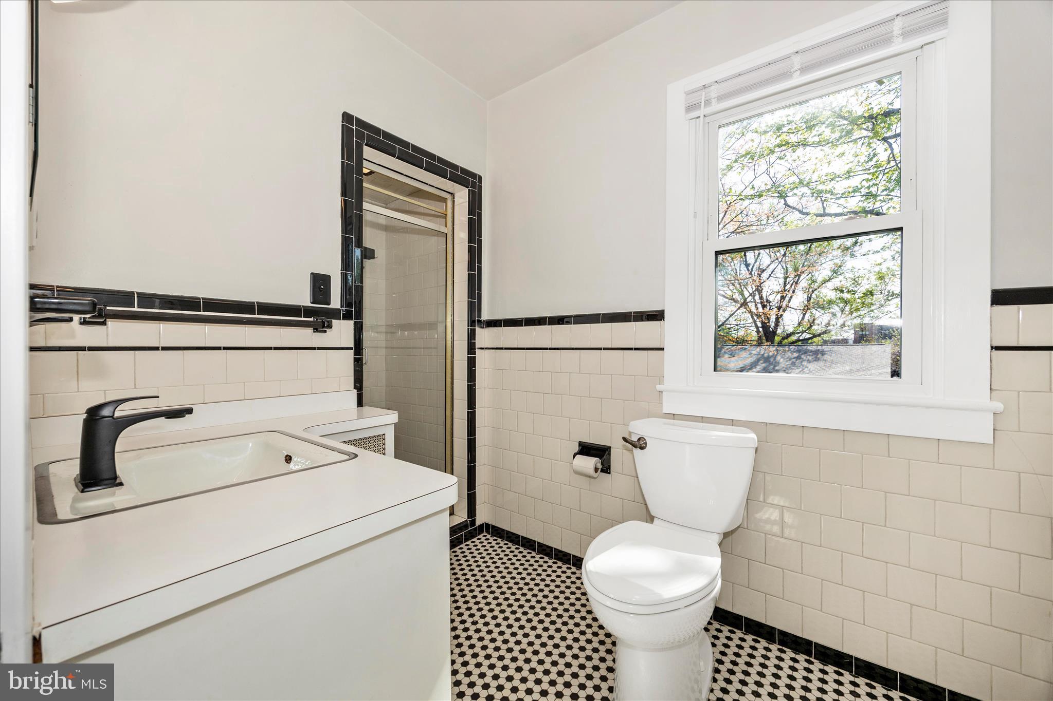 2 Catoctin Avenue Frederick, MD 21701 - Photo 32 of 63 a bathroom with a toilet sink and a window