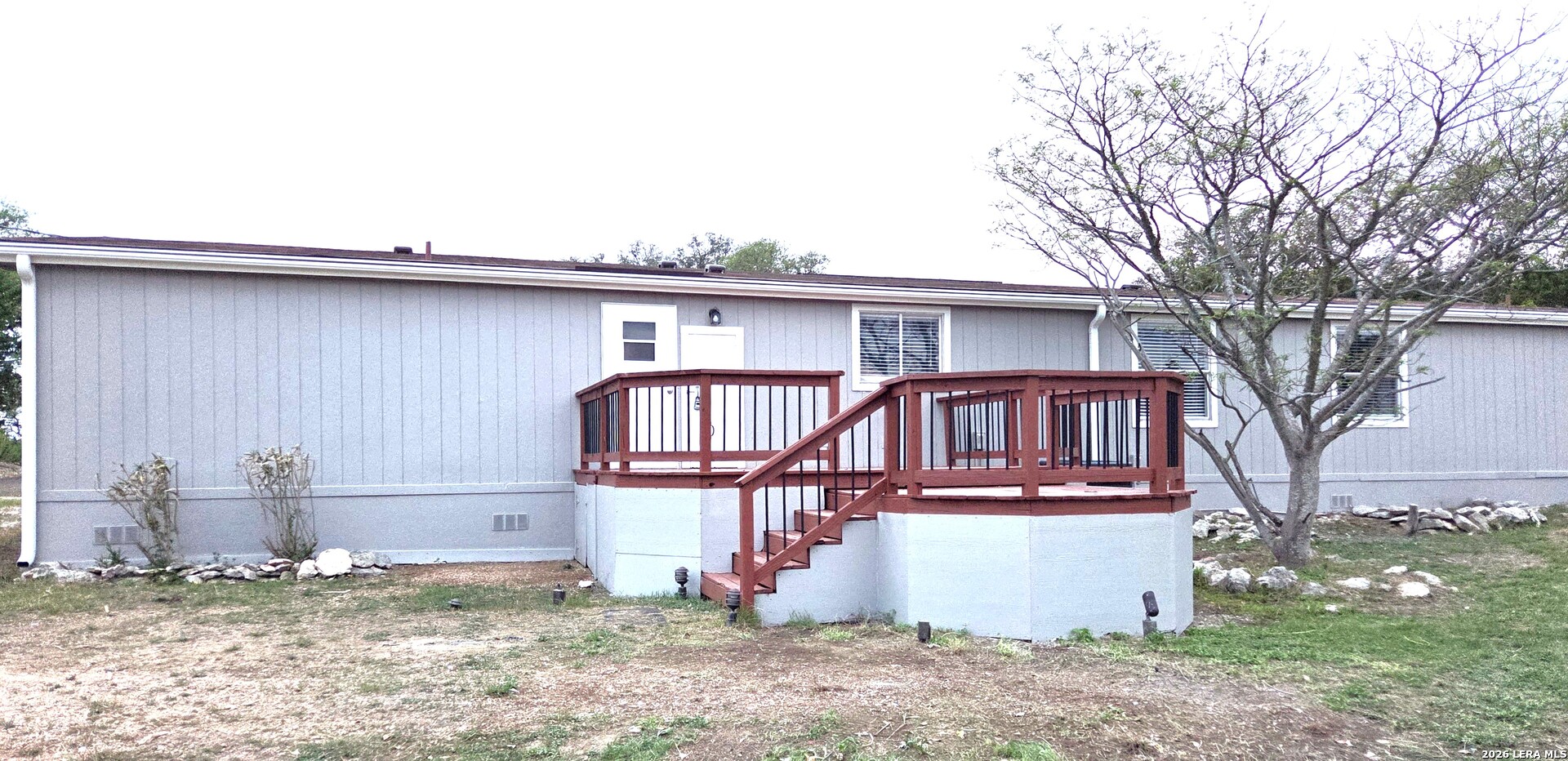 533 Las Hadas Spring Branch, TX 78070 - Photo 15 of 16 a view of a house with a wooden deck and a backyard