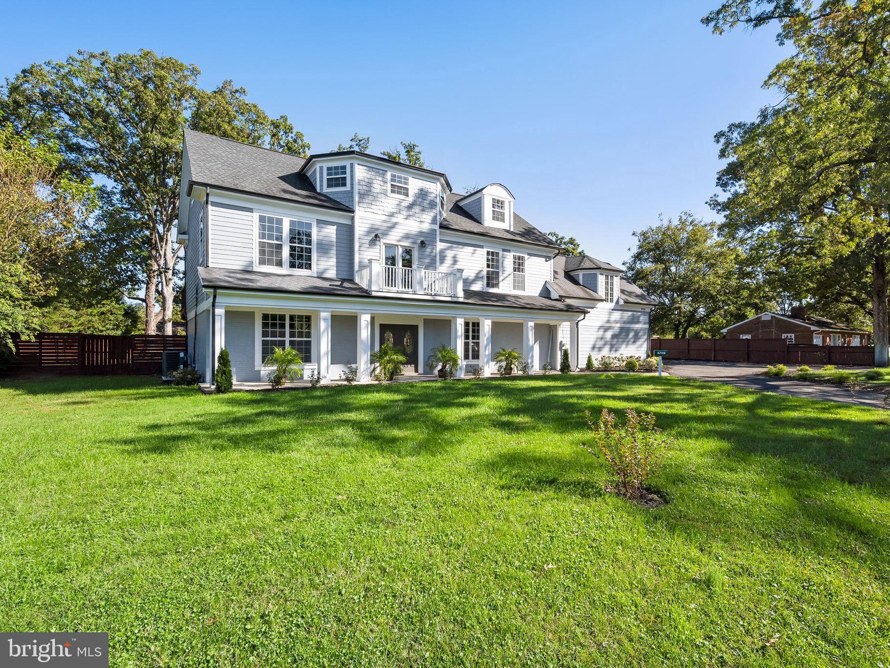 6709 Benson Drive Alexandria, VA 22306 - Photo 1 of 66 a front view of a house with a yard table and chairs