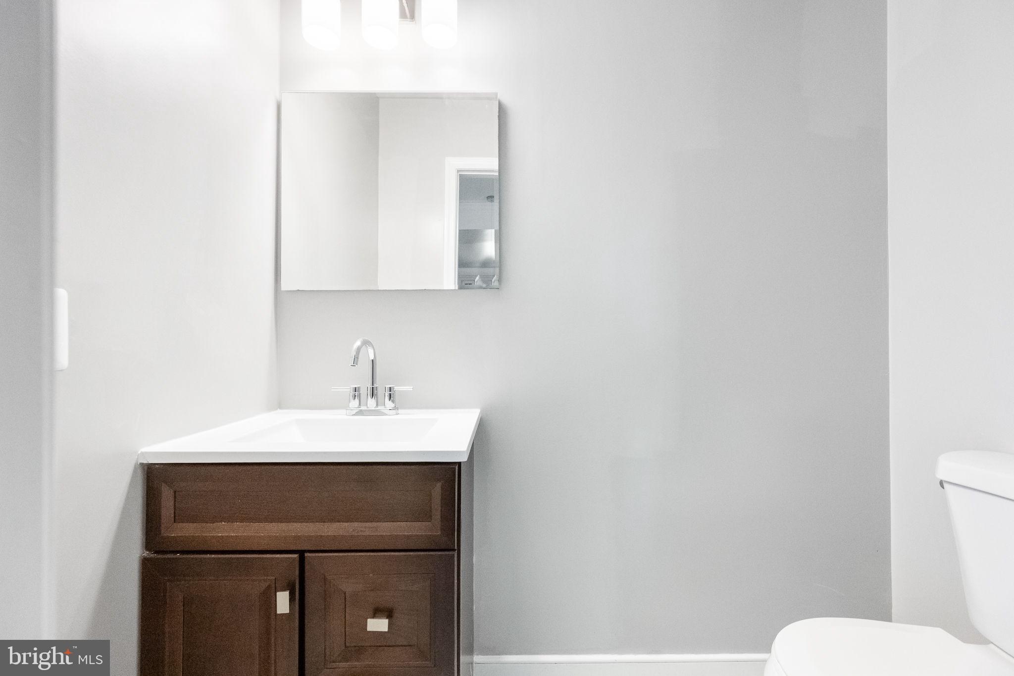 6709 Benson Drive Alexandria, VA 22306 - Photo 19 of 66 a bathroom with a sink a toilet and mirror