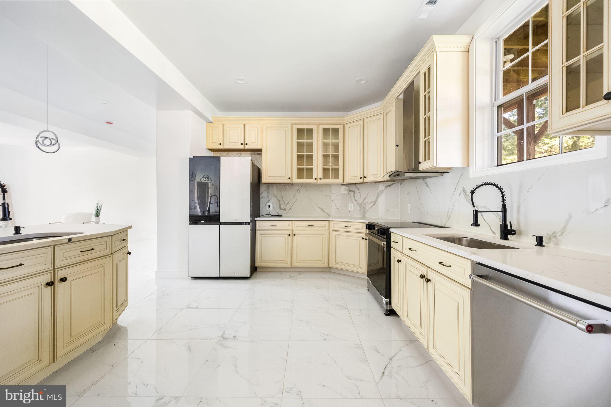6709 Benson Drive Alexandria, VA 22306 - Photo 23 of 66 a kitchen with stainless steel appliances a sink cabinets and a counter top space