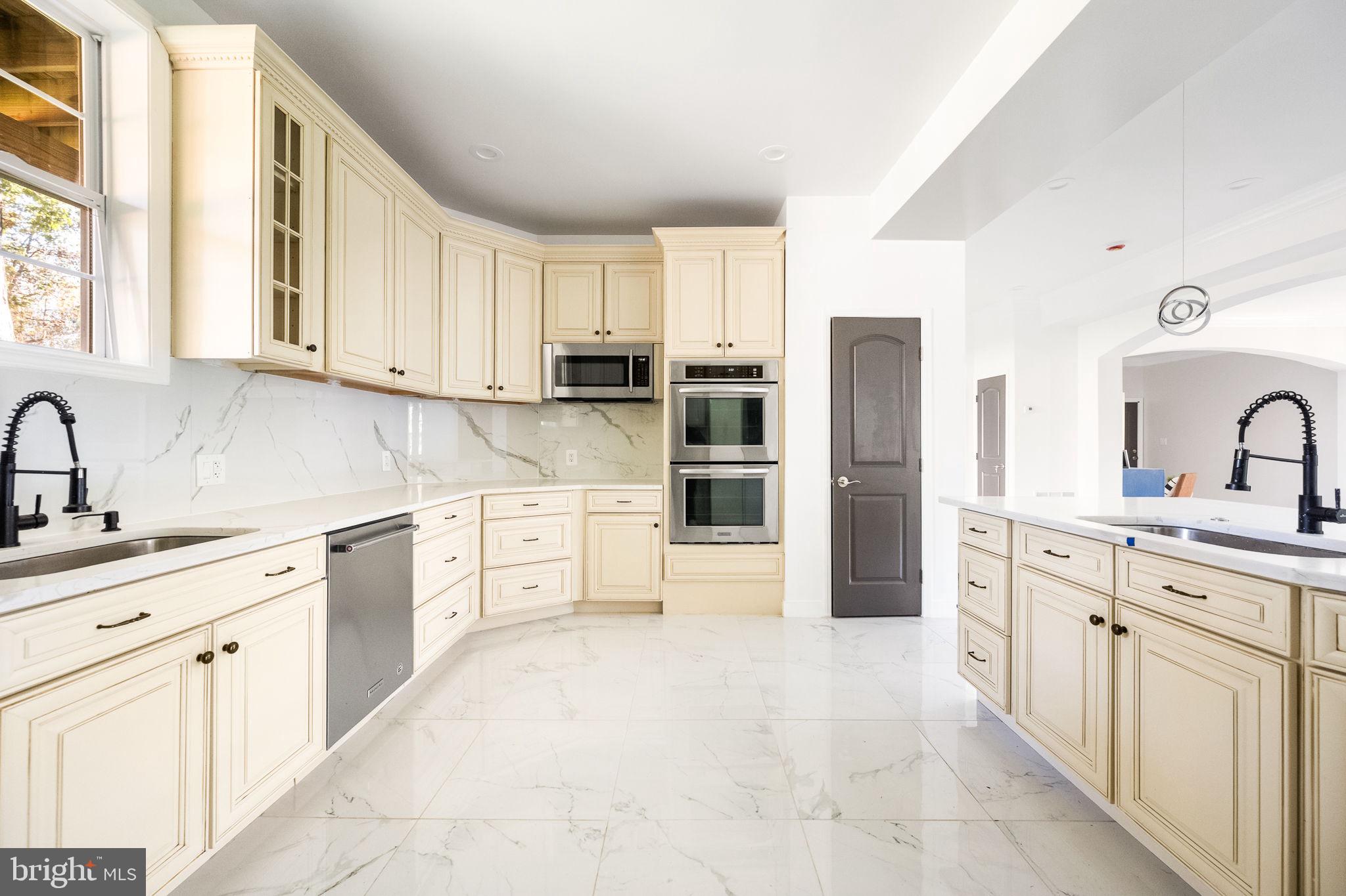 6709 Benson Drive Alexandria, VA 22306 - Photo 24 of 66 a kitchen with stainless steel appliances granite countertop a sink and cabinets