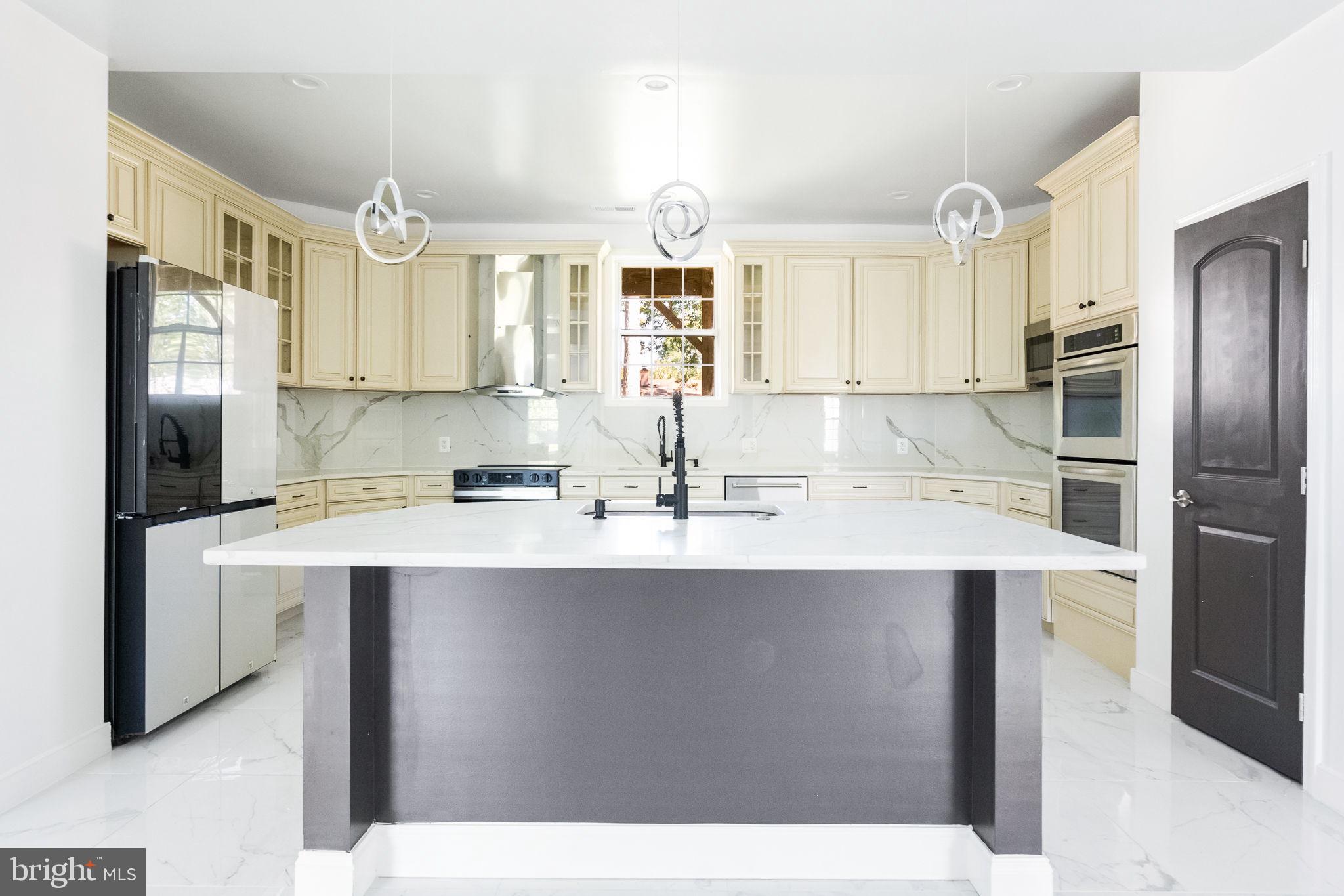 6709 Benson Drive Alexandria, VA 22306 - Photo 25 of 66 a kitchen with stainless steel appliances a sink stove refrigerator and cabinets