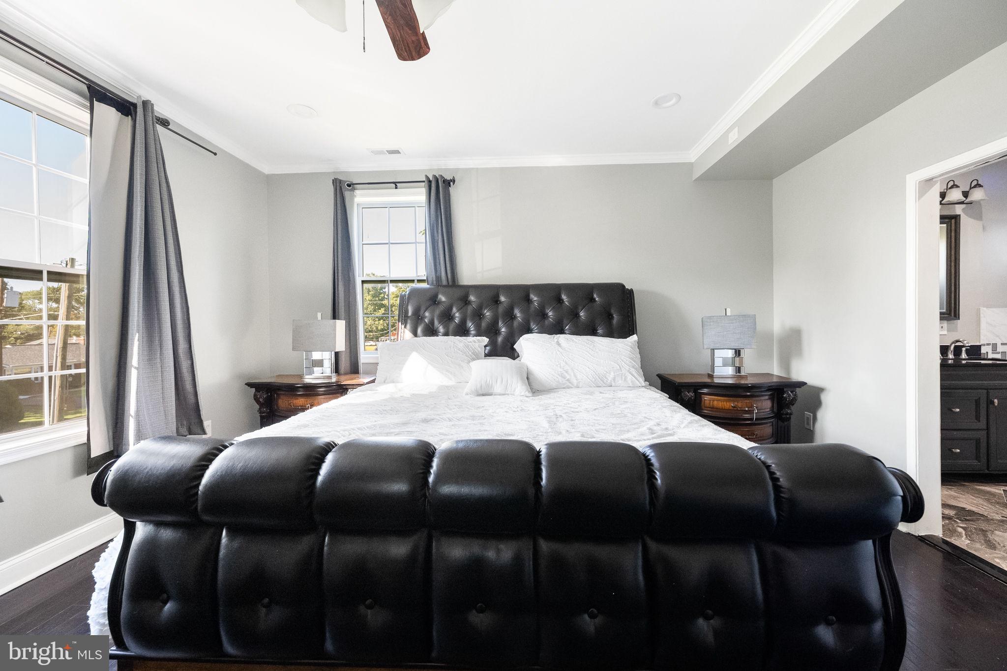 6709 Benson Drive Alexandria, VA 22306 - Photo 32 of 66 a bedroom with a bed a dresser and a large mirror