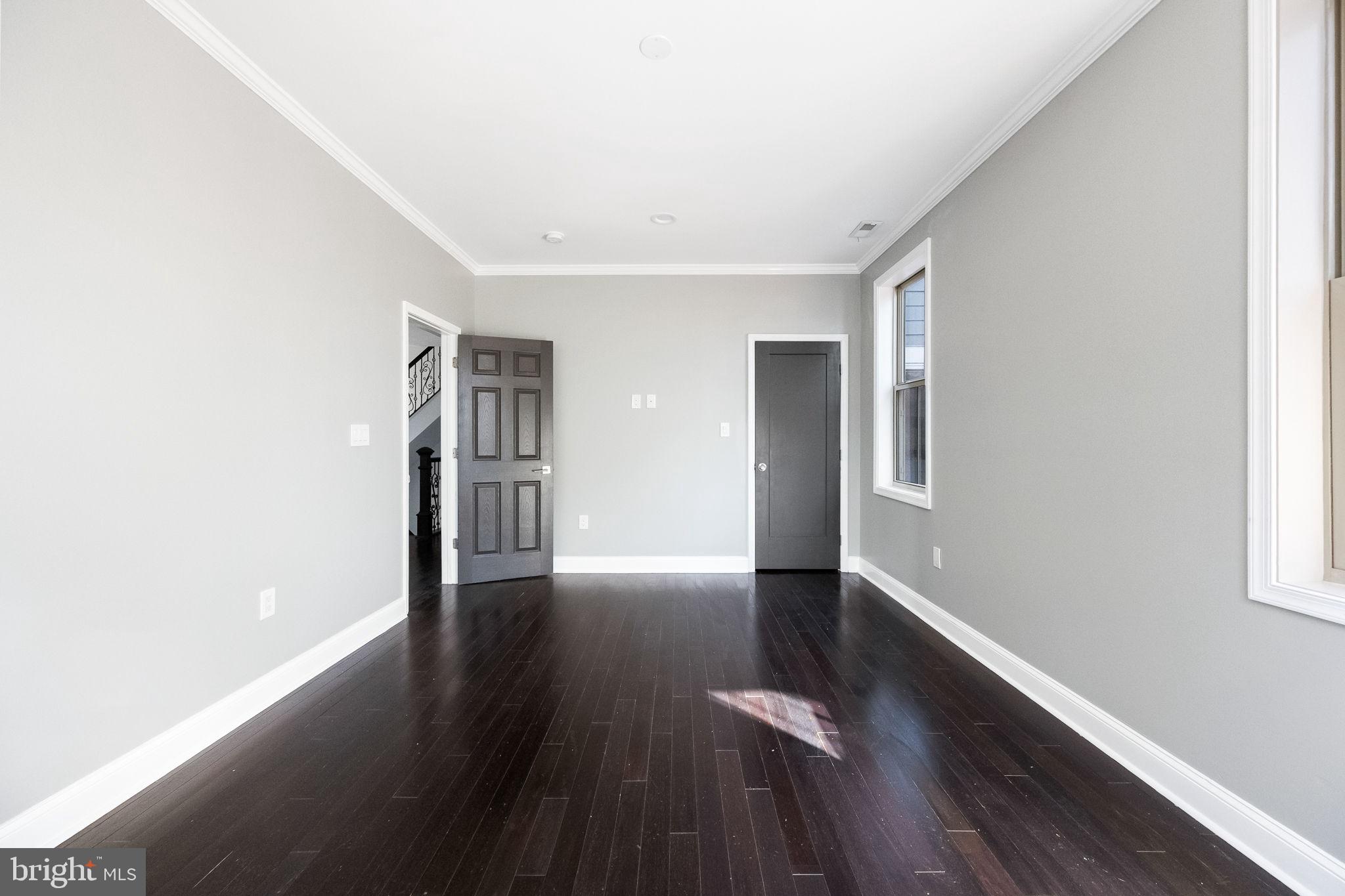 6709 Benson Drive Alexandria, VA 22306 - Photo 40 of 66 a view of an empty room with wooden floor and a window