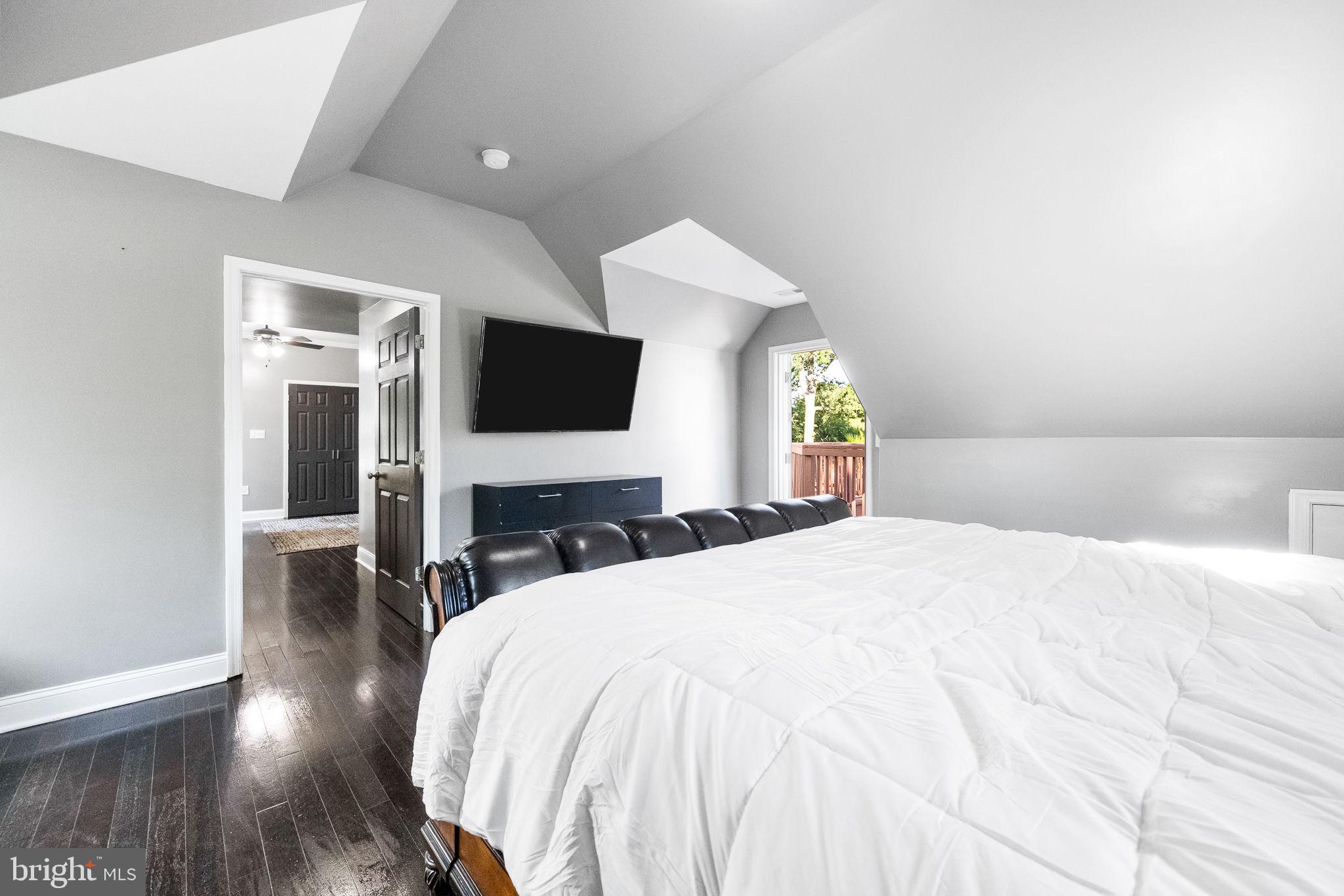 6709 Benson Drive Alexandria, VA 22306 - Photo 44 of 66 a bedroom with a bed and wooden floor