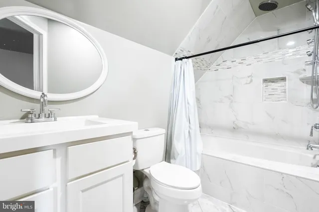 a bathroom with a sink toilet vanity and shower