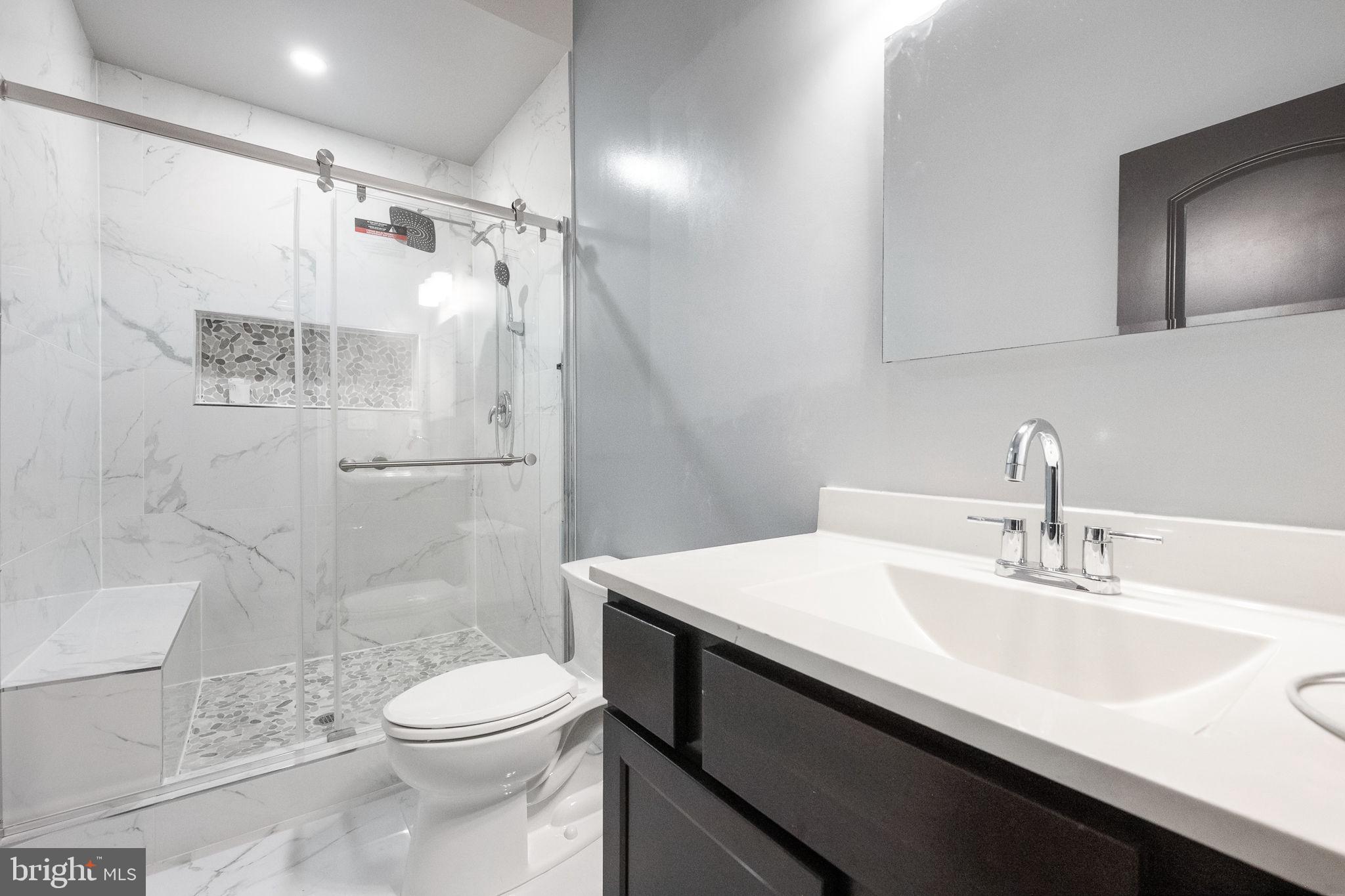 6709 Benson Drive Alexandria, VA 22306 - Photo 48 of 66 a bathroom with a sink toilet vanity and shower