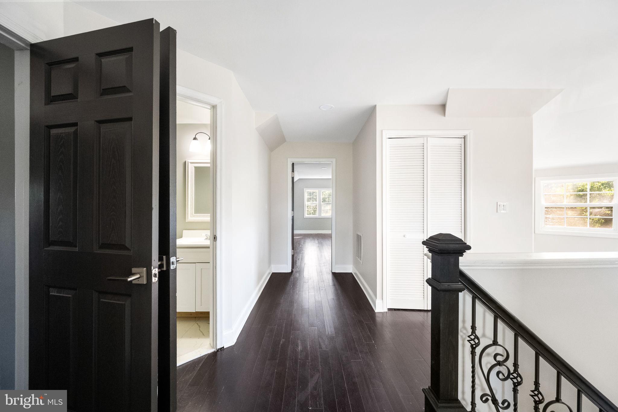6709 Benson Drive Alexandria, VA 22306 - Photo 50 of 66 a view of a hallway with wooden floor and staircase