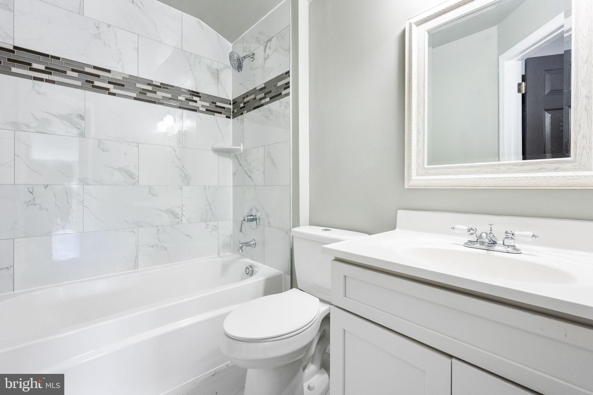 6709 Benson Drive Alexandria, VA 22306 - Photo 56 of 66 a bathroom with a sink toilet vanity and shower
