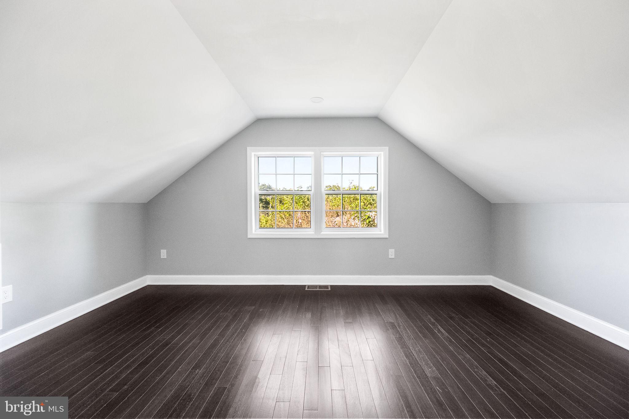 6709 Benson Drive Alexandria, VA 22306 - Photo 58 of 66 an empty room with wooden floor and windows