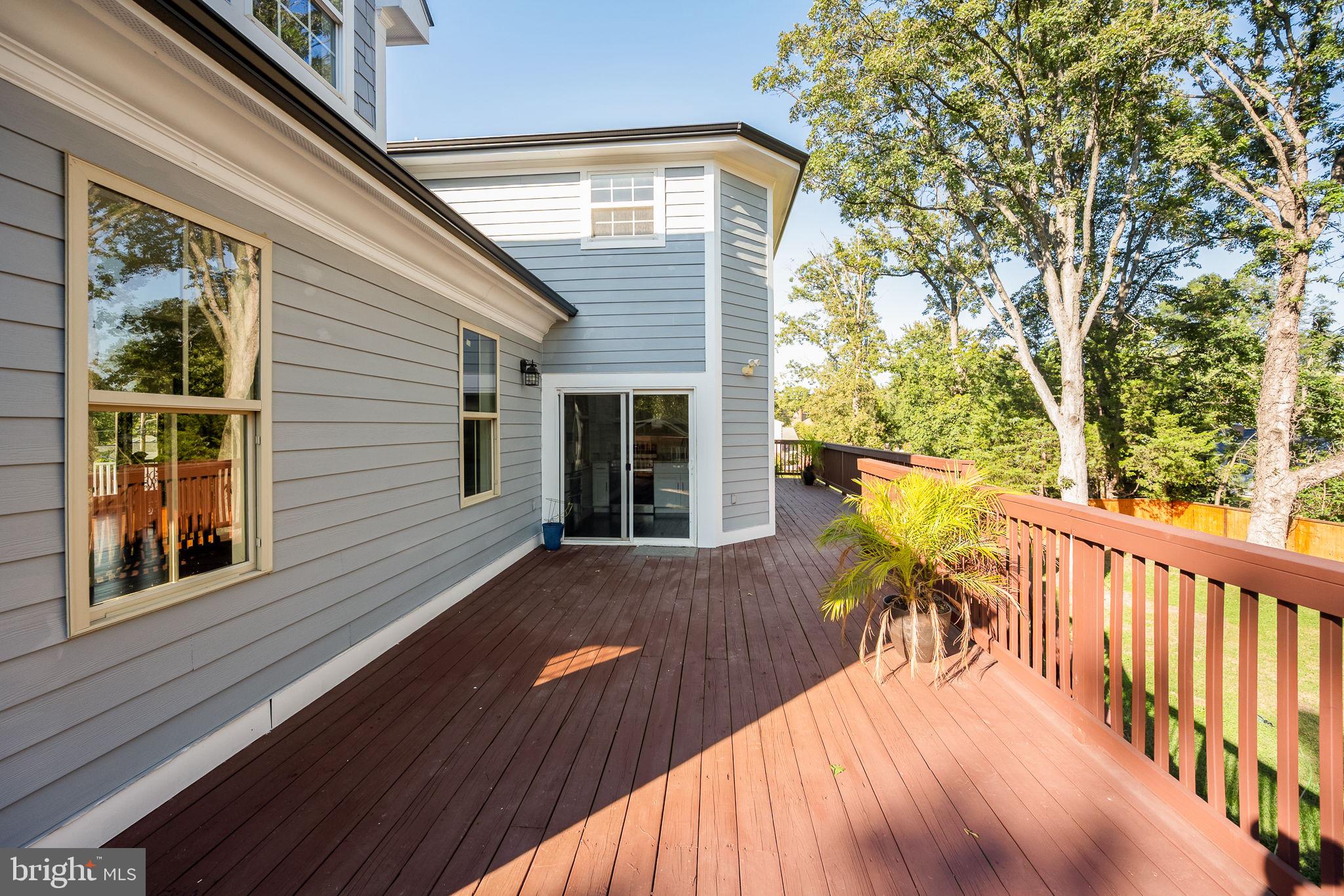 6709 Benson Drive Alexandria, VA 22306 - Photo 63 of 66 a view of a deck with table and chairs and wooden floor