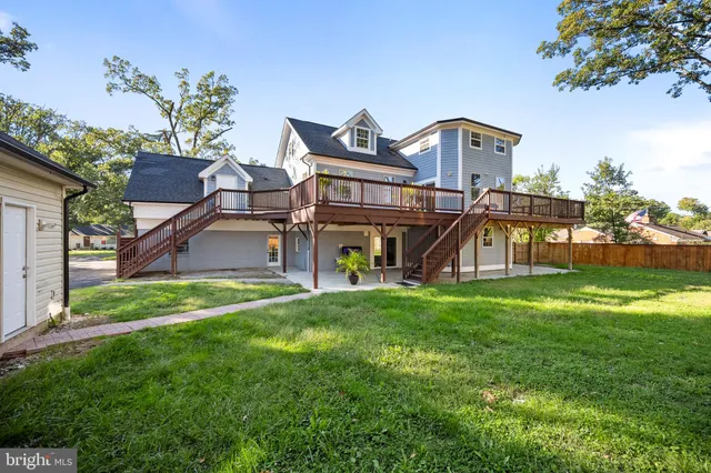 a view of a big house with wooden fence and two windows