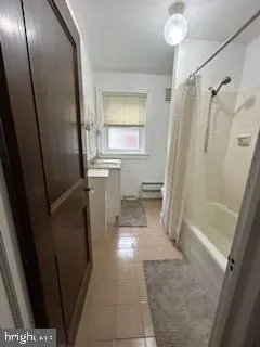 a bathroom with a sink a mirror toilet and bathtub