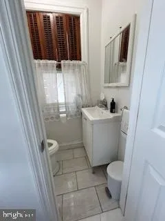 a bathroom with a sink toilet and mirror
