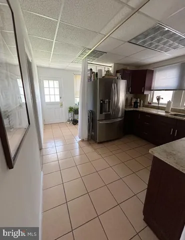 a kitchen with granite countertop a refrigerator and a sink