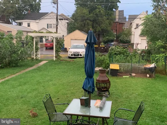a view of a chairs and table in backyard of the house