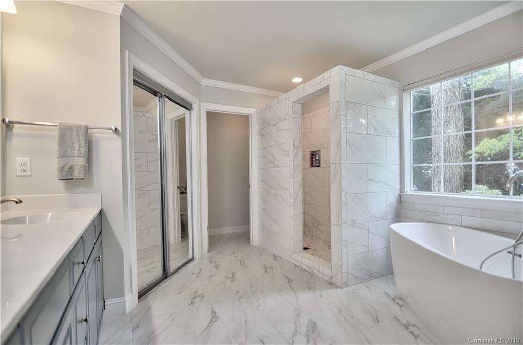 20210 Bascom Ridge Drive Cornelius, NC 28031 - Photo 15 of 35 a bathroom with a tub sink shower and mirror