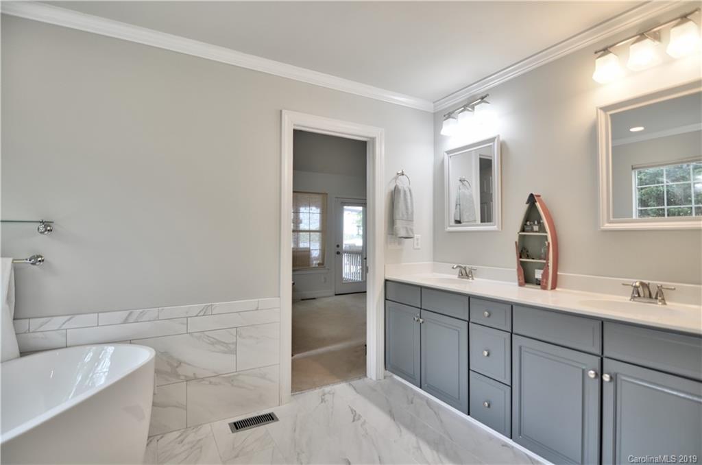 20210 Bascom Ridge Drive Cornelius, NC 28031 - Photo 16 of 35 a spacious bathroom with a double vanity sink a mirror and a bathtub